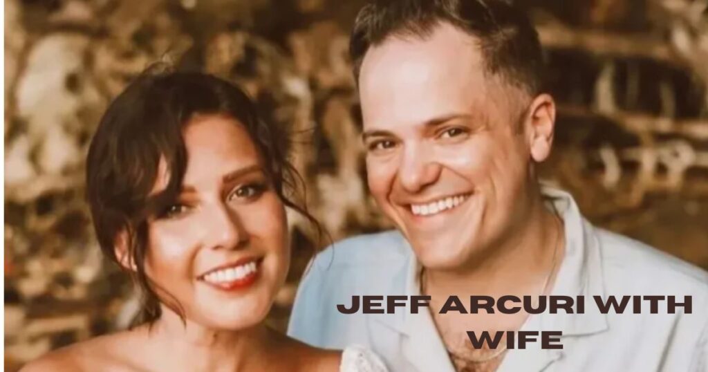 Jeff Arcuri is smiling. A clean shaved man with white skin tone. his wife is aslo standing here with him.